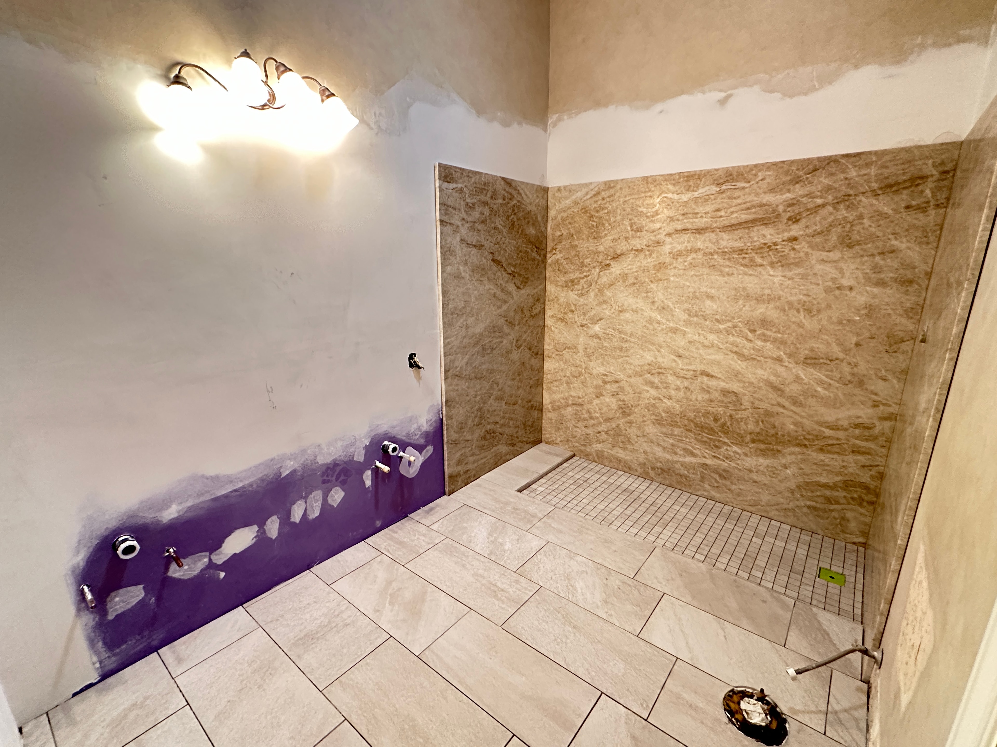 Bathroom renovation with marble tile walls and new flooring