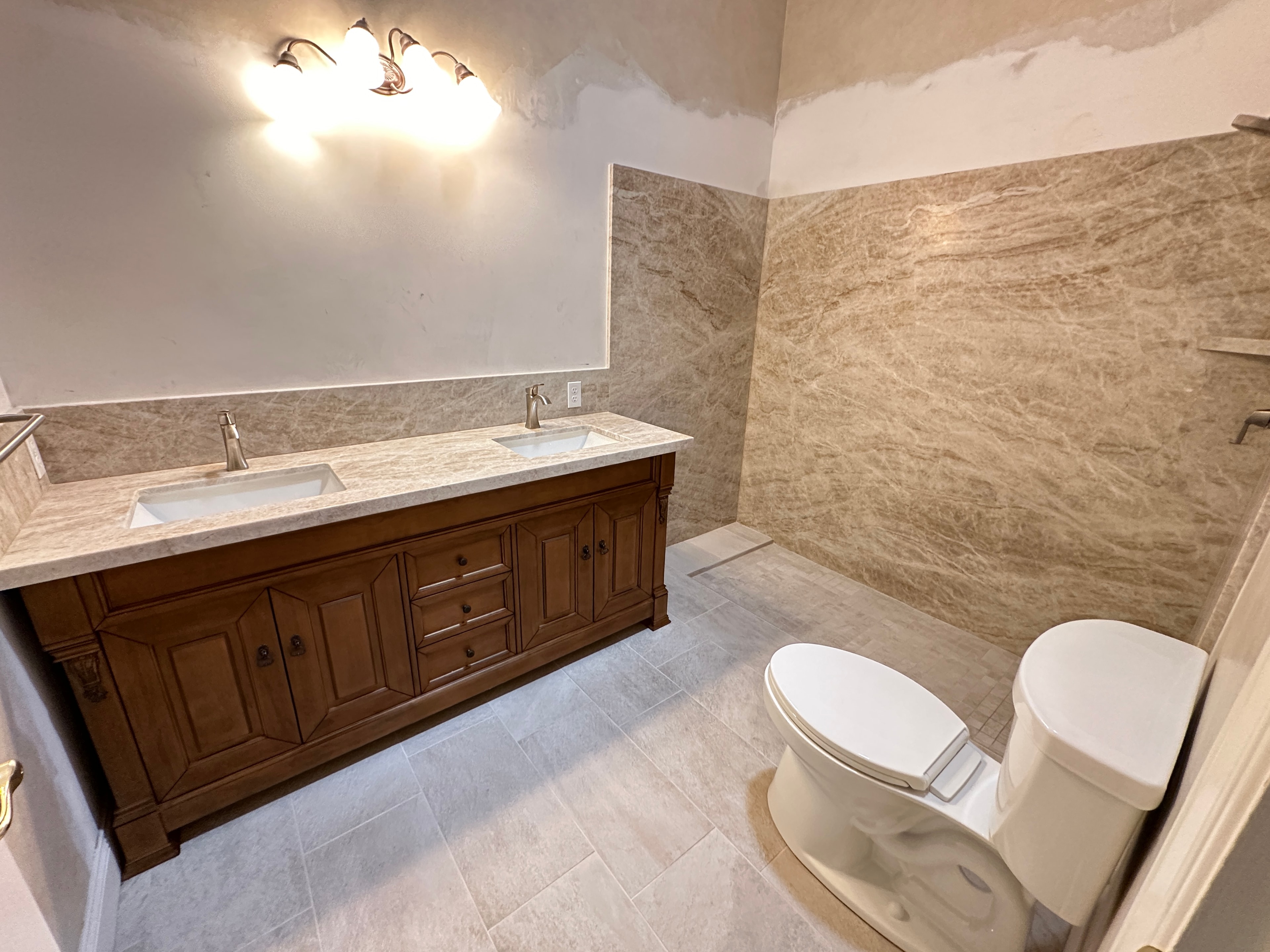 Completed bathroom with dual-sink vanity and marble countertop