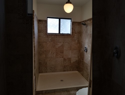 Bathroom shower stall with window light — HCIC