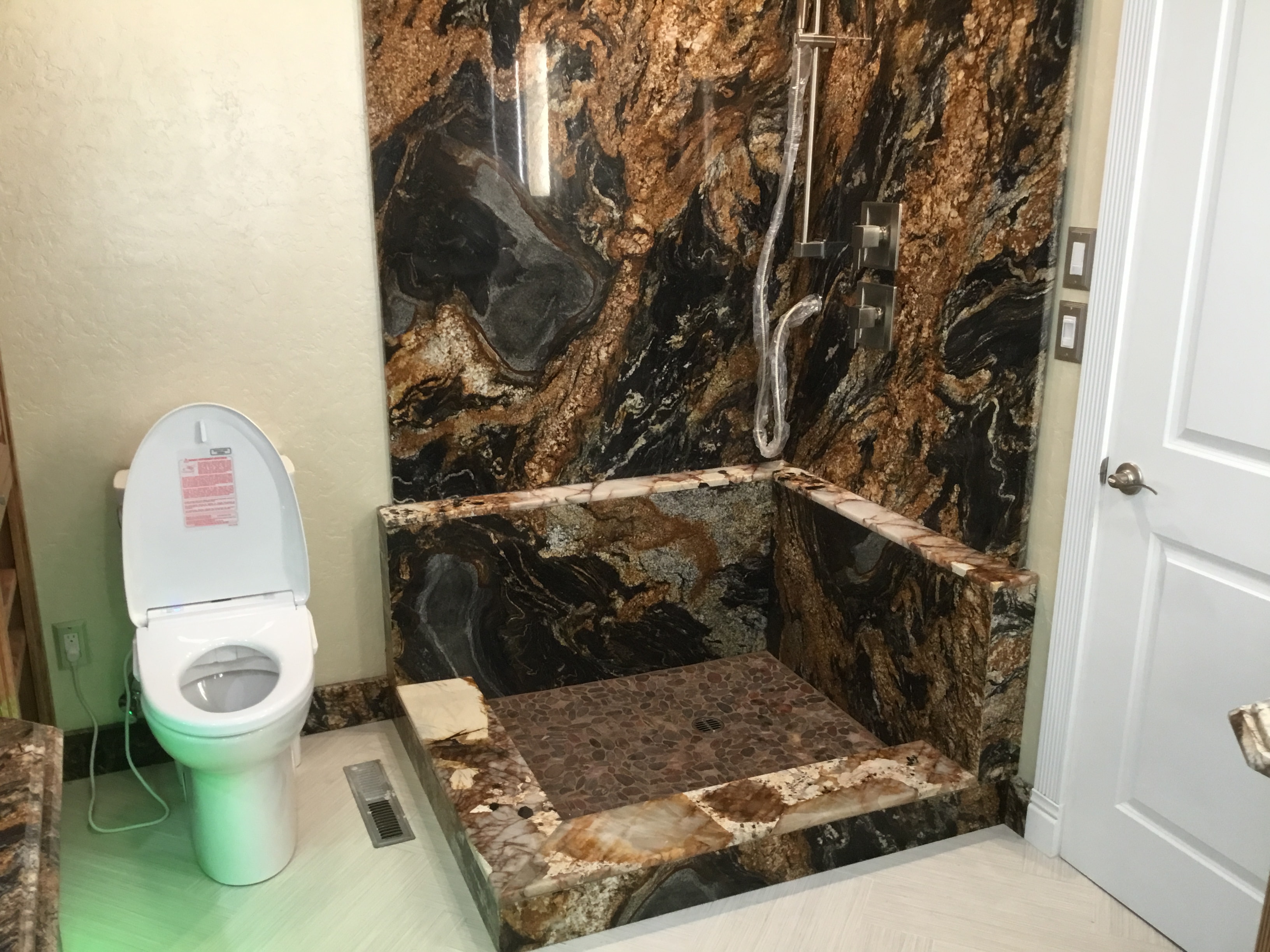 Bathroom with marble tile shower enclosure — HCIC