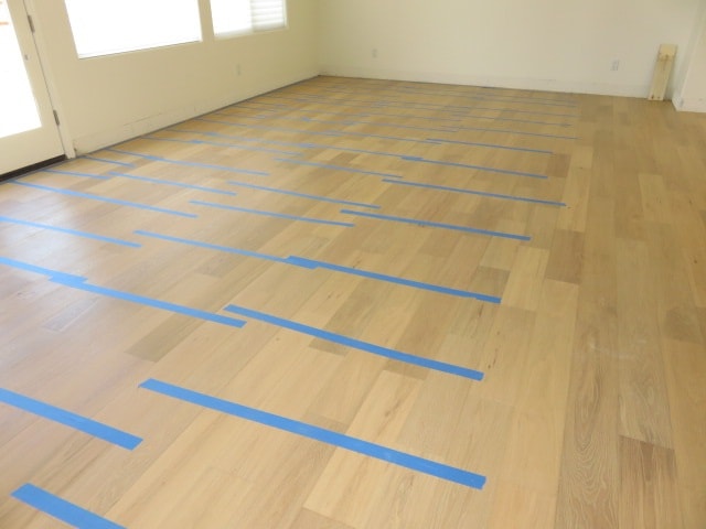 Wooden floor with blue tape layout — HCIC