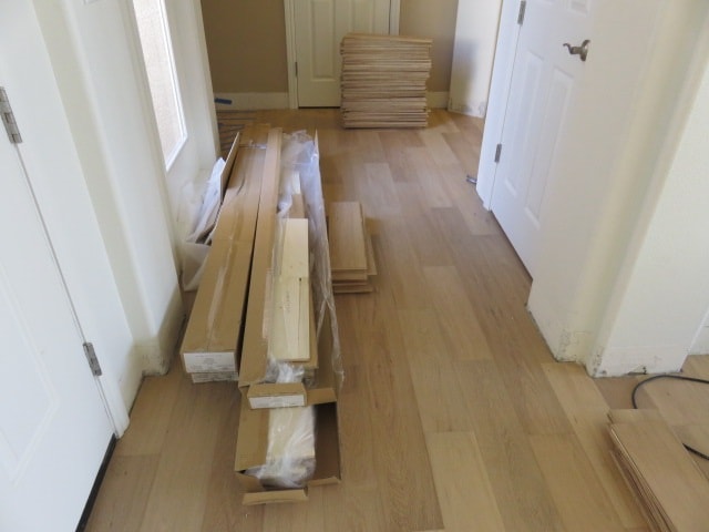Hardwood flooring materials laid out hallway — HCIC