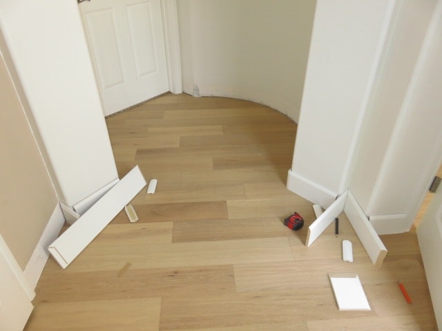 Empty hallway with white doors and baseboards — HCIC