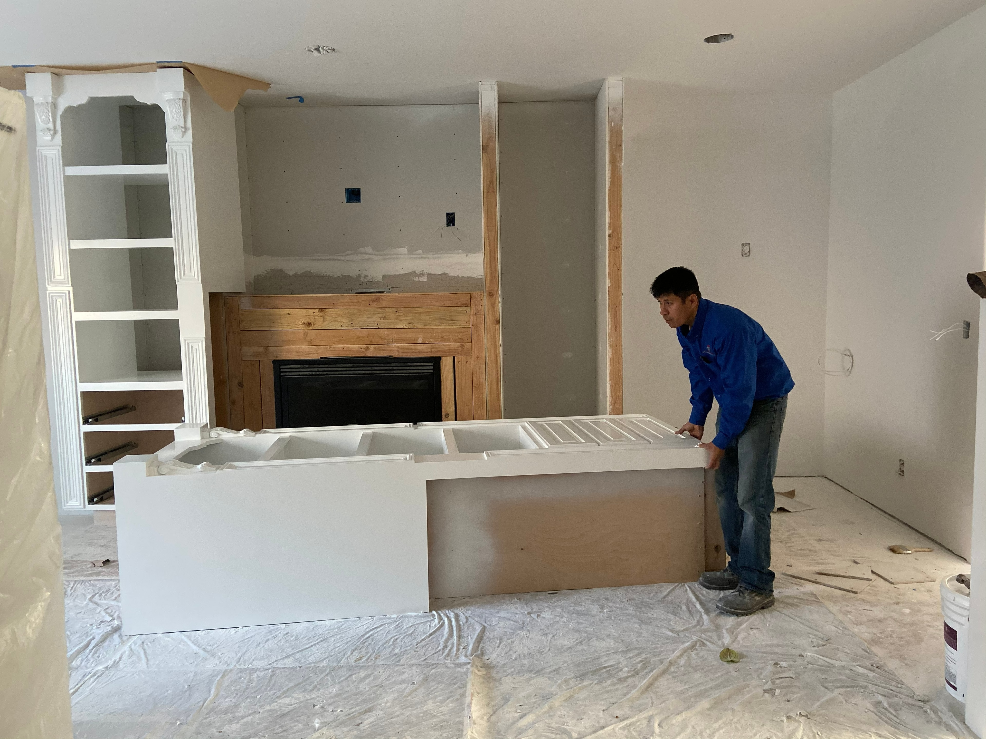Worker installing kitchen island during renovation — HCIC
