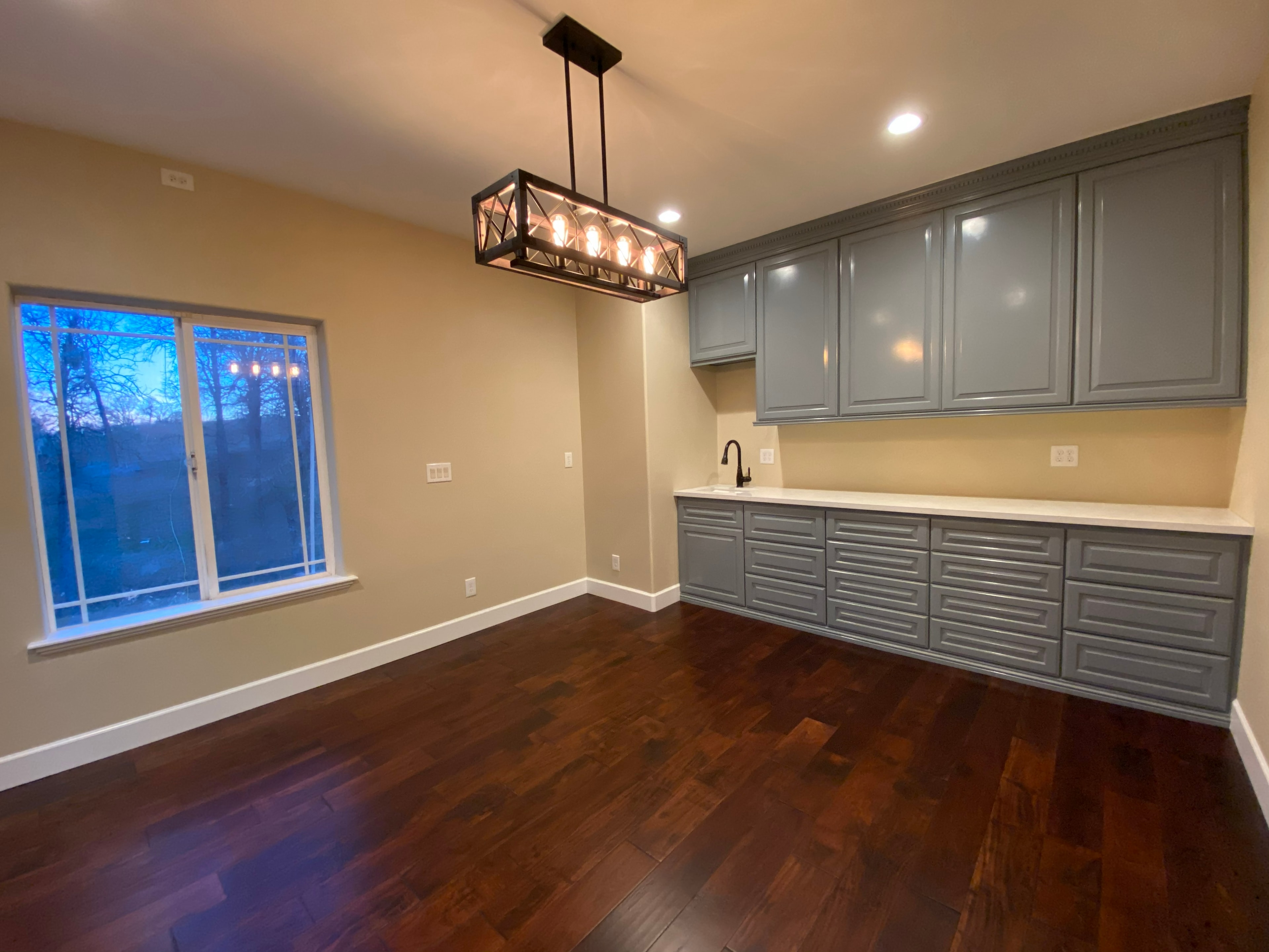 Modern kitchen with gray cabinetry hardwood floors — HCIC