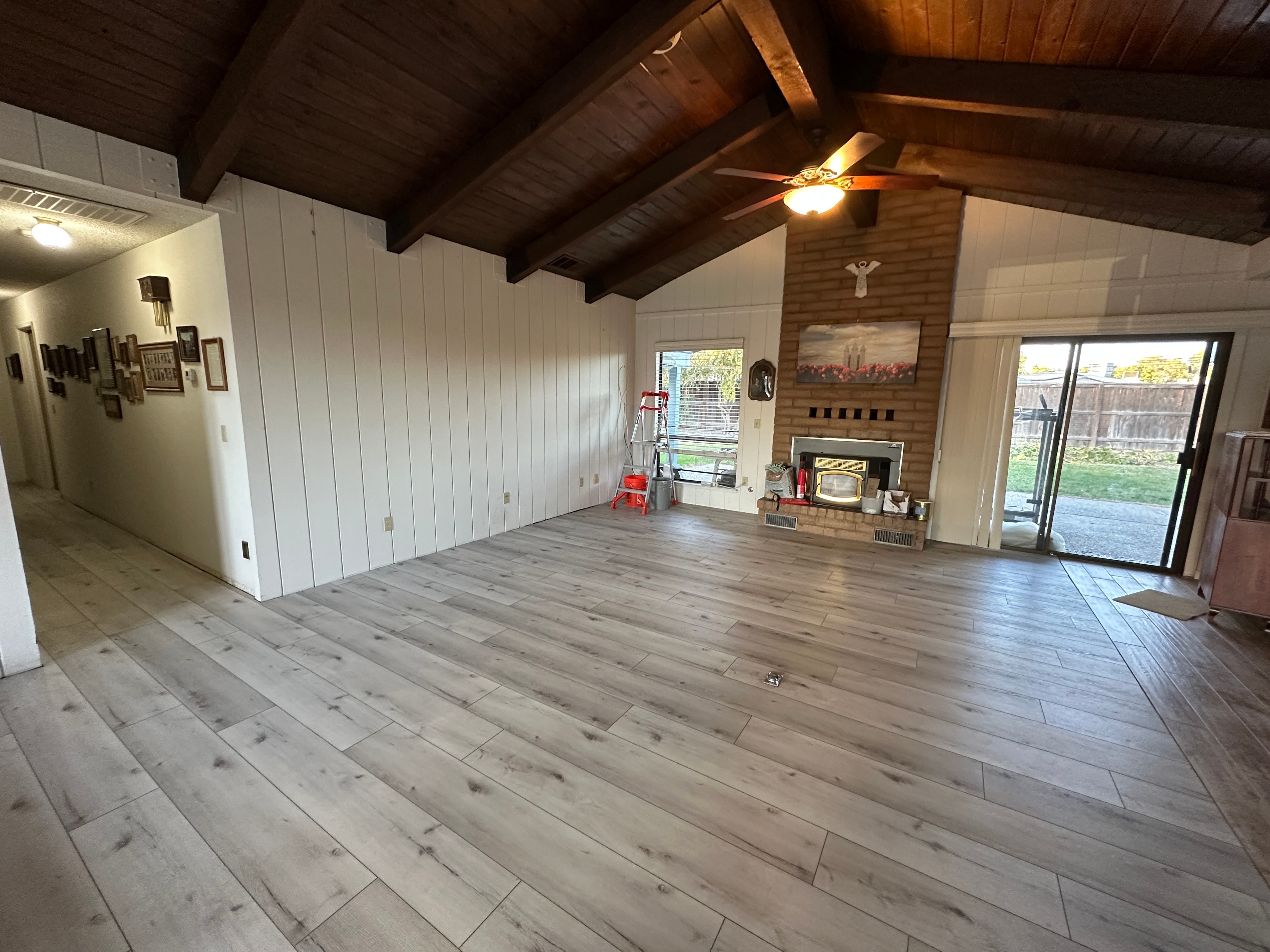 Spacious living room with brick fireplace — HCIC