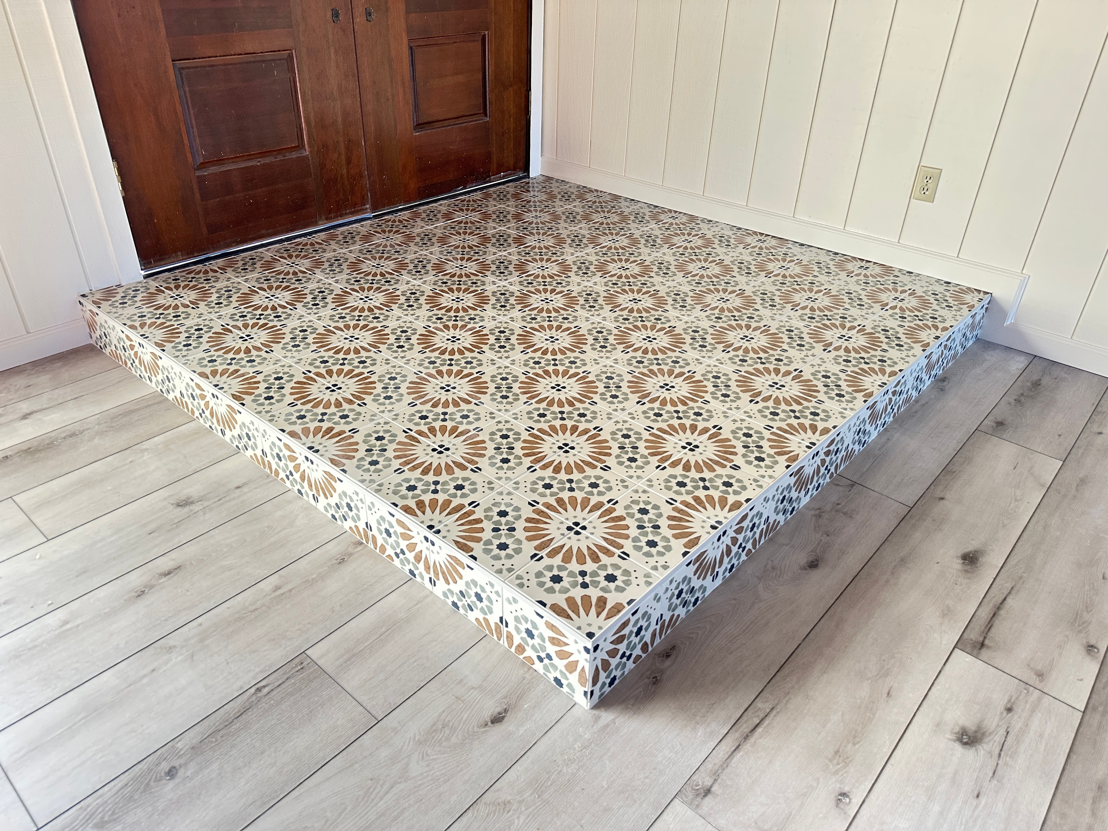 Patterned tile platform in entryway — HCIC